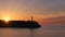Portocolom lighthouse sunrise, silhouette, beautiful colourful sky, sun beams, calm sea, Mallorca, Spain