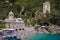 PORTOFINO, ITALY - APRIL 30, 2017: Crowded beach in front of the San Fruttuoso abbey during a sunny afternoon