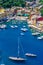 Portofino, Italy - colorful houses and yacht in little bay harbor. Liguria, Genoa province, Italy. Italian fishing village with