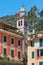 Portofino typical colorful houses and Divo Martino church bell tower