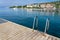 Portoroz central beach with pier and ladder into the water resort building background