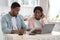 Portraif Of Shocked Black Spouses Checking Financial Documents In Kitchen