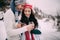 Portrain of smiling couple with cups of hot tea in their hands during winter walk.