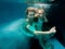 Portrair of young dancing couple underwater