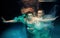 Portrair of young dancing couple underwater