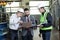 Portrait of a 3 men in a airplane manufactory. Two company managers and one factory worker deciding future plans.