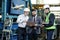 Portrait of a 3 men in a airplane manufactory. Two company managers and one factory worker deciding future plans.