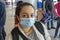 Portrait of a 35-40-year-old woman in a medical mask and contact lenses at the airport, check-in for departure from the country, p