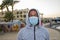 Portrait of a 40-year-old black man wearing a medical mask on an outdoor tourist beach. Perhaps he works as a lifeguard or guide f