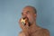 Portrait of 40s bald beard Japanese man eating red apple fruit foot for health