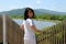 Portrait of 45 year old Russian brunette woman turned back and looking at the camera. windy summer day near lake