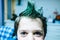 Portrait of 9 year old baby boy with crest of green colored hair