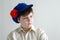 Portrait of aboy teenager in Russian national cap with cloves