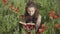 Portrait of absorbed young woman in headphones reading book outdoors. Beautiful Caucasian brunette lady enjoying