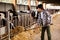 Portrait of active chinese female employee working in cowshed on farm