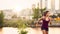 Portrait of active millenial woman jogging at dusk with an urban cityscape and sunset in the background