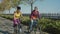 Portrait of active multiethnic female friends biking on park alley