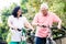 Portrait of active senior couple standing on bicycles
