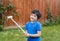 Portrait active young boy playing with wooden hammer toys in the garden, Positive child boy playin goutdoor in sunny day spring or