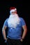 Portrait actor male in cap and beard of Santa Claus with a sheet of paper for notes in the hands