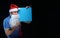 Portrait actor male in cap and beard of Santa Claus with a sheet of paper for notes in the hands