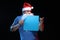 Portrait actor male in cap and beard of Santa Claus with a sheet of paper for notes in the hands