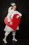 Portrait of actress lady in clown costume with red heart at work