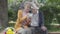Portrait adorable adult couple looking old photos remembering happy moments sitting on a bench in the park. Mature