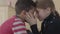 Portrait of adorable african american boy and pretty blond caucasian girl touching foreheads each other. Girl hold boys