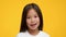 Portrait Of Adorable Asian Preschool Girl Posing Over Yellow Background