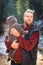Portrait of adorable bearded father with his son in a funny jumpsuit with ears winter outdoor