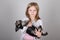 Portrait of adorable blond young girl smiling holding Schnauzer puppy