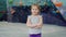 Portrait of adorable child little girl standing alone in climbing gym looking at camera