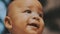 Portrait of adorable curious multiracial dark skin baby looking up.