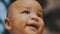 Portrait of adorable curious multiracial dark skin baby looking up.