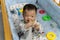 Portrait adorable and cute happy Asian Chinese baby boy playing alone