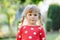 Portrait of adorable cute toddler girl of three years. Beautiful baby with blond hairs looking and smiling at the camera