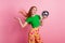 Portrait of adorable gorgeous girl with fluttering redhead hair wear stylish top palm hold discoball isolated on pink