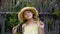 Portrait of adorable happy teen girl with braids posing in wicker hat