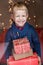 Portrait of adorable kid with gift boxes. Christmas. Birthday