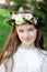 Portrait of adorable kid girl with floral wreath