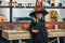 portrait of adorable kid in witch halloween costume leaning on wooden tabletop