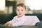 Portrait of adorable messy baby sitting in high chair