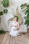 Portrait of adorable pregnant woman in white dress