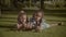Portrait of adorable sisters lying on green grass