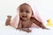 Portrait of adorable six month crawling African American baby covered in towel after bath time, happy smiling sweet little girl