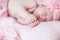 Portrait of adorable sleeping baby girl over pink, infant child.