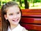 Portrait of adorable smiling little girl child schoolgirl teenager outdoors