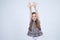 Portrait of adorable smiling little girl isolated on a white. Toddler with her hands up. Happy child. Cheerful and positive emotio