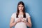 Portrait of adorable sweet nervous lady crossing fingers enough violence concept on blue background